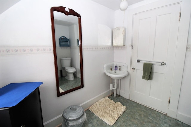 bathroom with tile flooring and toilet