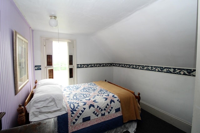 bedroom with lofted ceiling