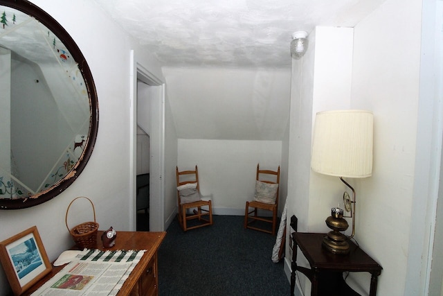 hall featuring dark colored carpet