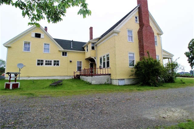 rear view of house featuring a wooden deck