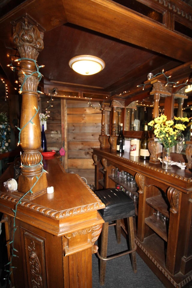 bar featuring wood walls and carpet flooring