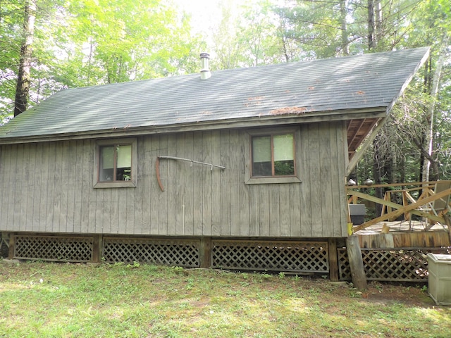 view of home's exterior with a yard and a wooden deck