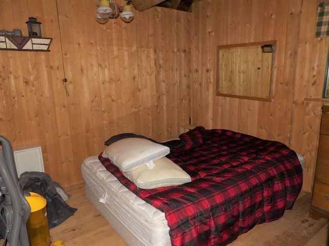 bedroom featuring wood walls and light wood-type flooring