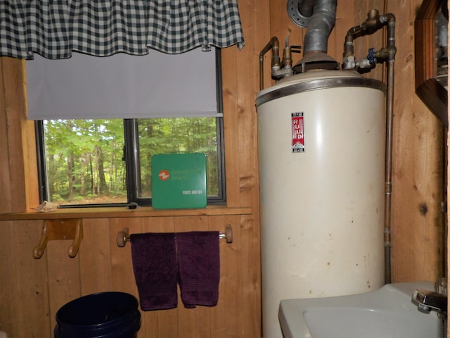 utility room with sink and gas water heater