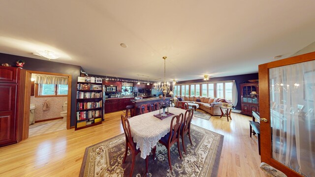 dining room featuring light hardwood / wood-style flooring and a chandelier