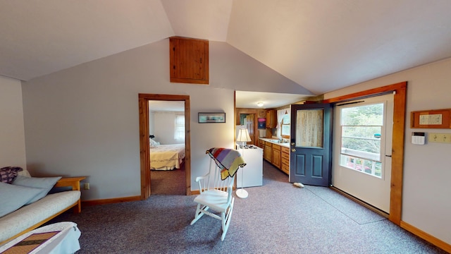 living room featuring light carpet, baseboards, and vaulted ceiling