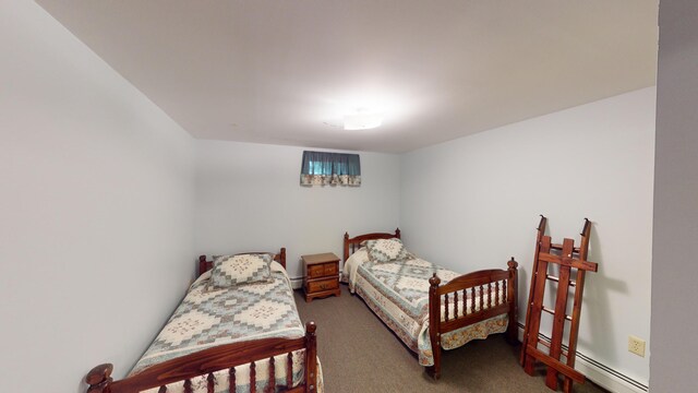 carpeted bedroom with a baseboard heating unit