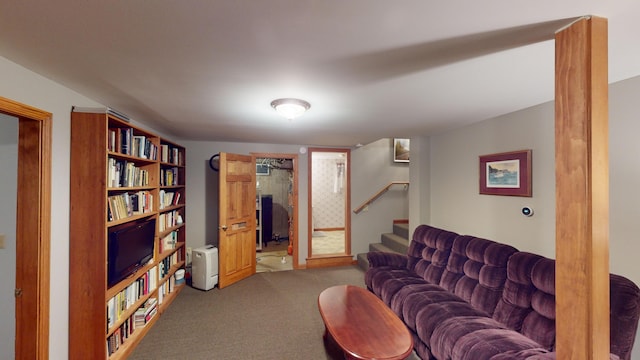 living area with carpet floors and stairs