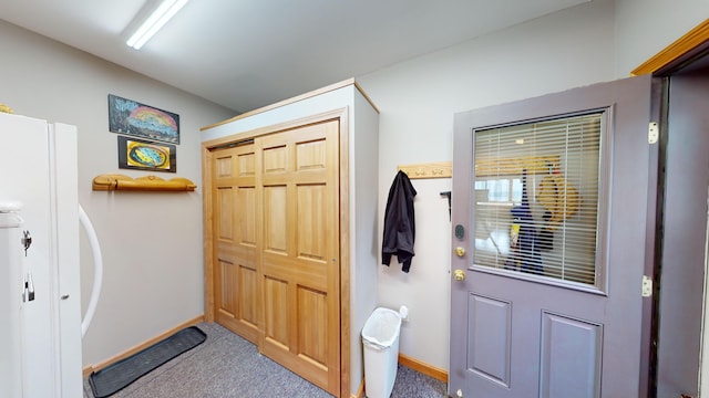 doorway to outside with carpet floors and baseboards