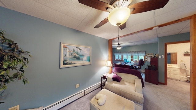 sitting room with a paneled ceiling, ceiling fan, baseboard heating, and carpet floors