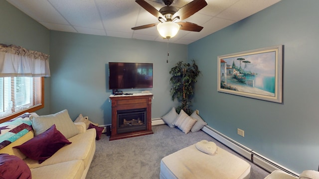 carpeted living room with a baseboard heating unit, a paneled ceiling, and ceiling fan