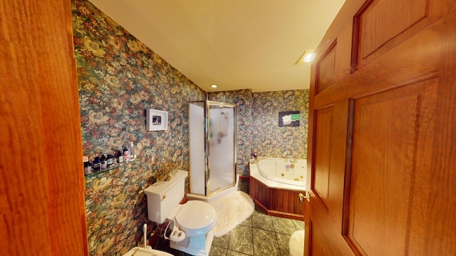 bathroom with toilet, wallpapered walls, a shower stall, and a whirlpool tub