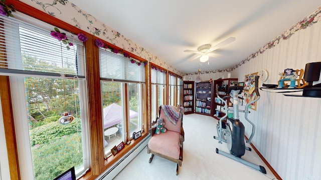 sunroom / solarium with a wealth of natural light and ceiling fan