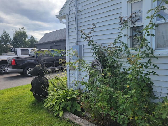 view of side of home featuring a lawn