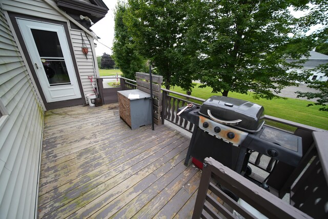 wooden deck with a grill