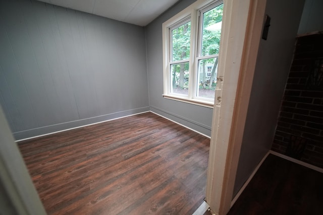 spare room featuring dark hardwood / wood-style floors