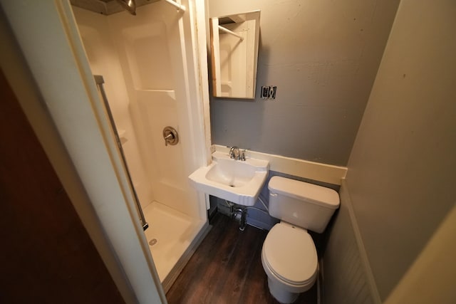 bathroom featuring walk in shower, sink, toilet, and hardwood / wood-style flooring