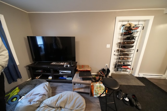 living room featuring ornamental molding and baseboard heating