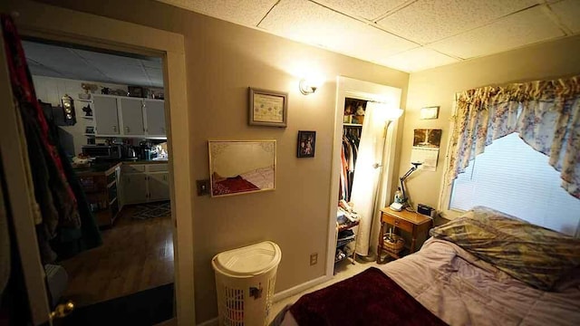 bedroom featuring a closet and a drop ceiling