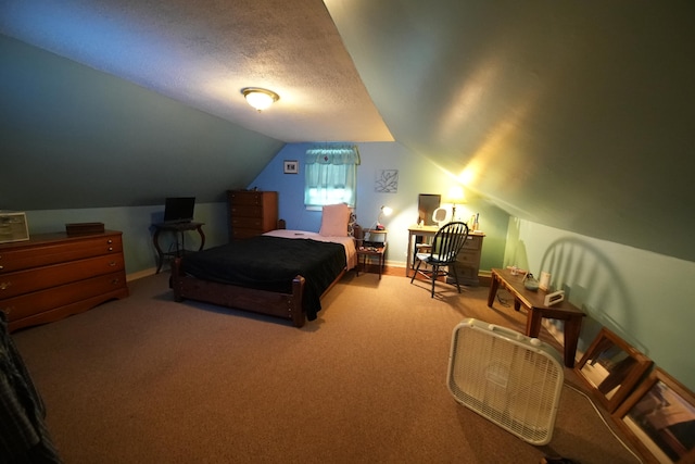 bedroom with carpet flooring, a textured ceiling, and vaulted ceiling