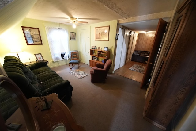 carpeted living room with ceiling fan