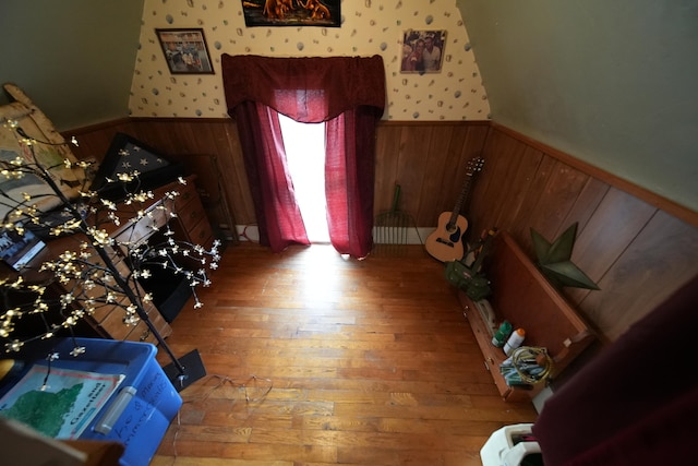 interior space featuring wooden walls and light hardwood / wood-style flooring