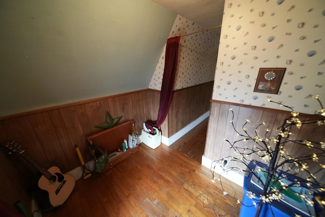 staircase with wood walls and hardwood / wood-style flooring