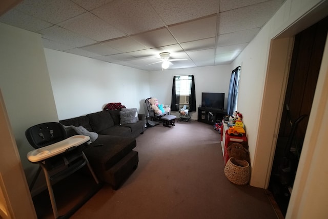 carpeted living room with a paneled ceiling and ceiling fan