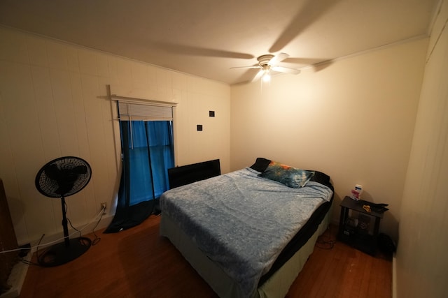 bedroom with ceiling fan and dark wood-type flooring