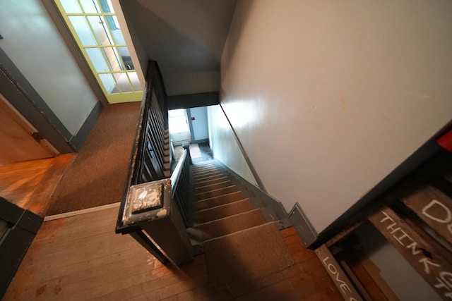 stairs featuring a high ceiling and dark wood-type flooring