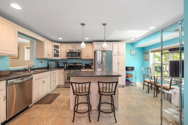 76 Heritage Dr Unit 5, Wells, ME 04090 - kitchen with appliances with stainless steel finishes, a sink, a kitchen island, a skylight, and recessed lighting