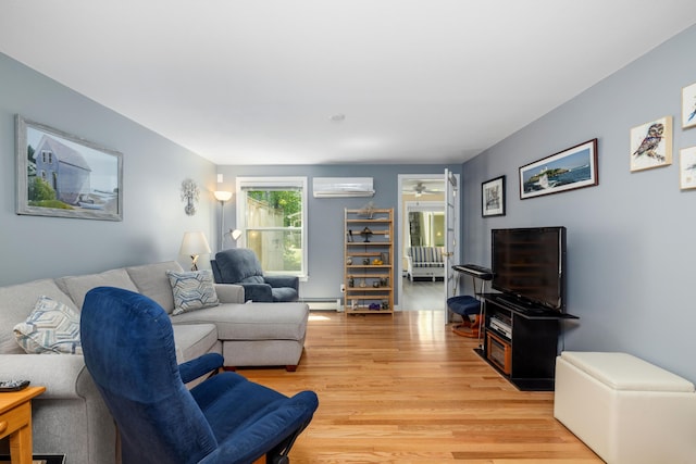 76 Heritage Dr Unit 5, Wells, ME 04090 - living room with a wall unit AC, a baseboard heating unit, light wood-style floors, and ceiling fan