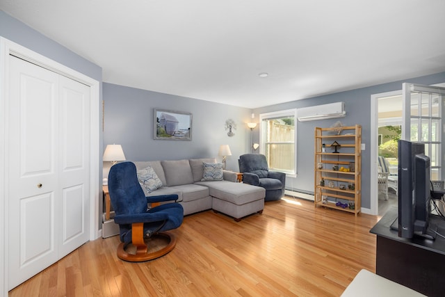 76 Heritage Dr Unit 5, Wells, ME 04090 - living area featuring a wall mounted AC, baseboard heating, light wood finished floors, and healthy amount of natural light