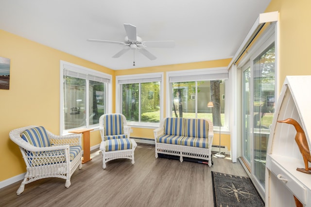 76 Heritage Dr Unit 5, Wells, ME 04090 - sunroom with a baseboard heating unit, baseboard heating, wood finished floors, and healthy amount of natural light
