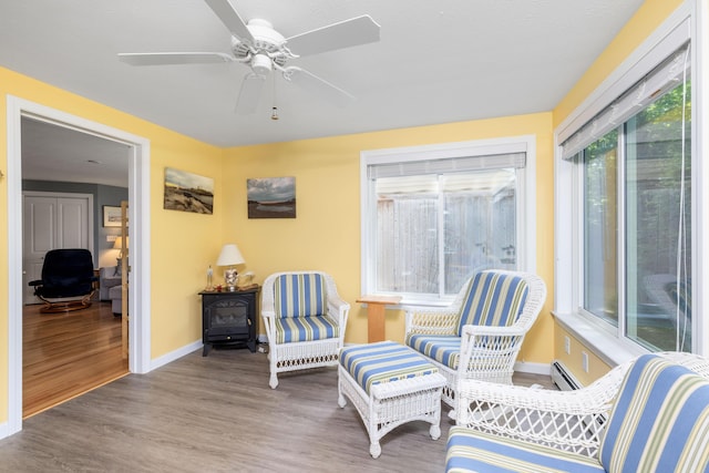 76 Heritage Dr Unit 5, Wells, ME 04090 - sunroom featuring plenty of natural light, wood finished floors, and baseboard heating