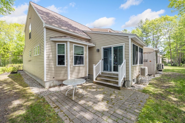 76 Heritage Dr Unit 5, Wells, ME 04090 - rear view of house with entry steps, a patio, roof with shingles, and cooling unit