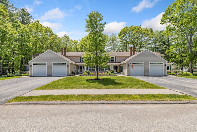 76 Heritage Dr Unit 5, Wells, ME 04090 - view of front of home with a garage, a chimney, a front lawn, and asphalt driveway