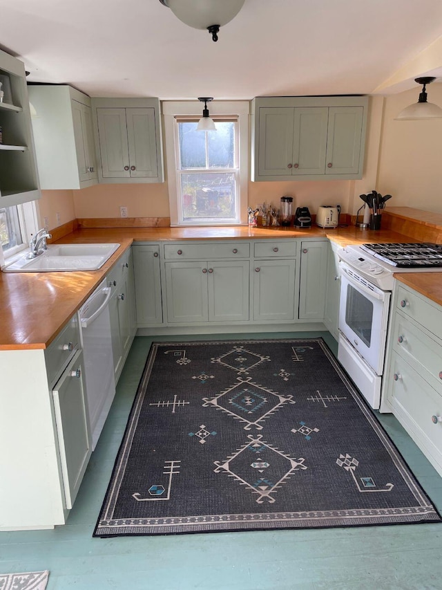 122 Main St, Cranberry Isles, ME 04646 - kitchen with stainless steel dishwasher, sink, and white gas stove