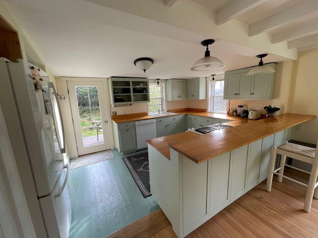 122 Main St, Cranberry Isles, ME 04646 - kitchen with kitchen peninsula, refrigerator, hanging light fixtures, beamed ceiling, and white dishwasher