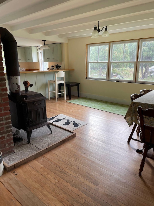 122 Main St, Cranberry Isles, ME 04646 - sitting room featuring light hardwood / wood-style flooring, a wood stove, and beam ceiling