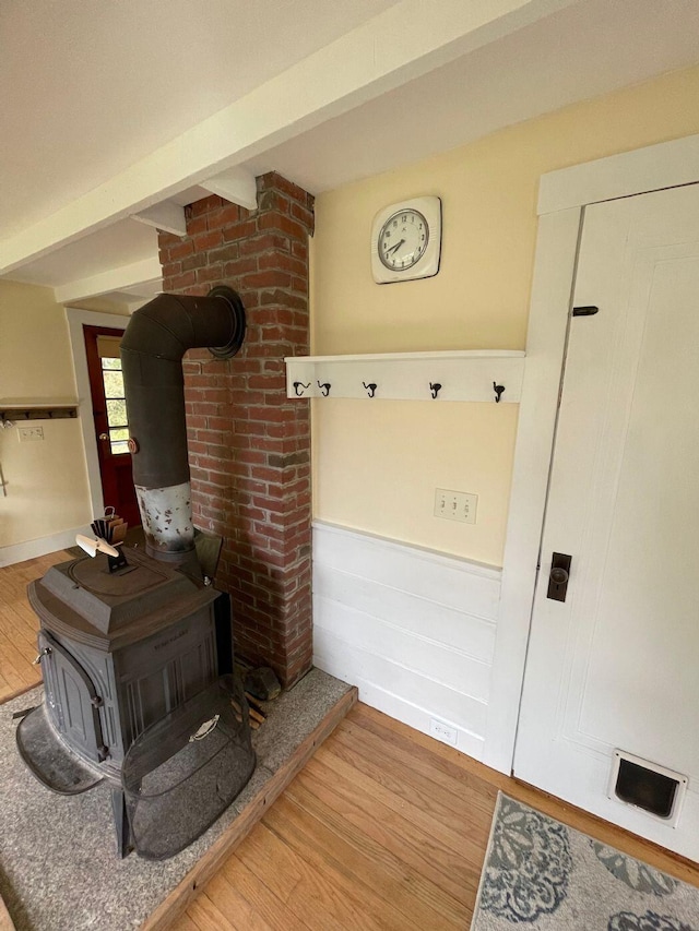 122 Main St, Cranberry Isles, ME 04646 - interior space featuring brick wall, light hardwood / wood-style floors, and a wood stove