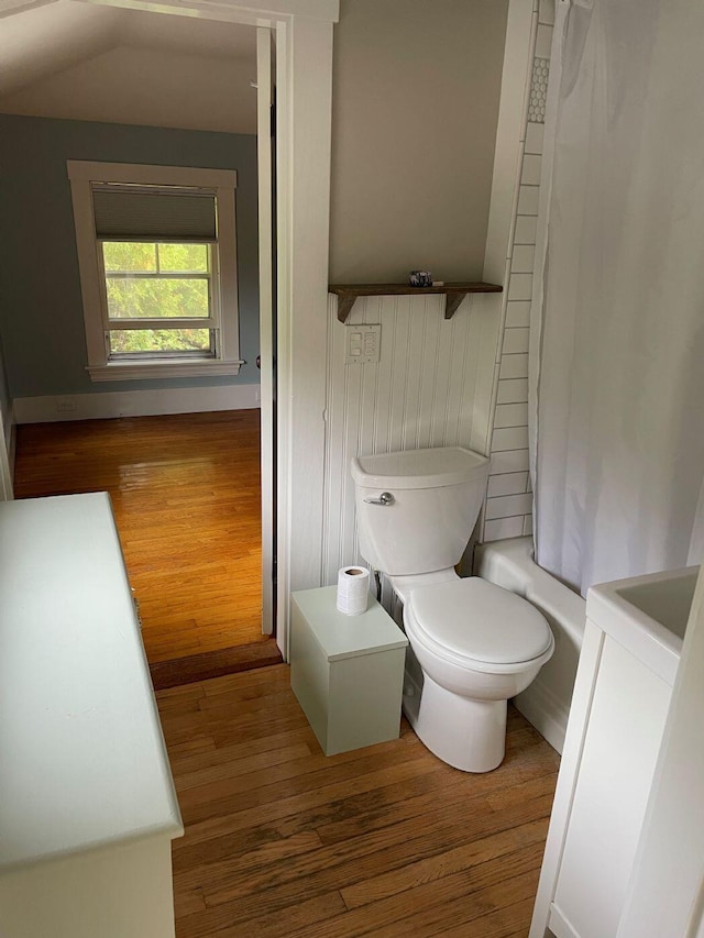 122 Main St, Cranberry Isles, ME 04646 - full bathroom featuring wood-type flooring, washer / dryer, toilet, vanity, and shower / bath combo with shower curtain