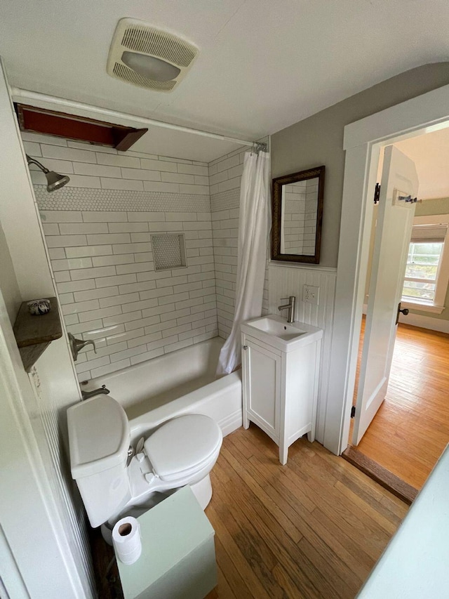 122 Main St, Cranberry Isles, ME 04646 - full bathroom with shower / tub combo with curtain, wood-type flooring, vanity with extensive cabinet space, and toilet
