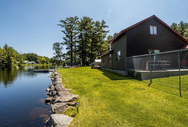 exterior space with a lawn and a water view