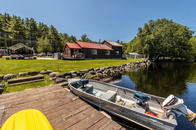 dock area with a yard and a water view