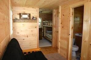 bathroom with toilet and wood walls