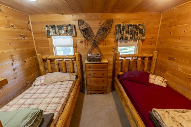 carpeted bedroom with wooden walls and wood ceiling