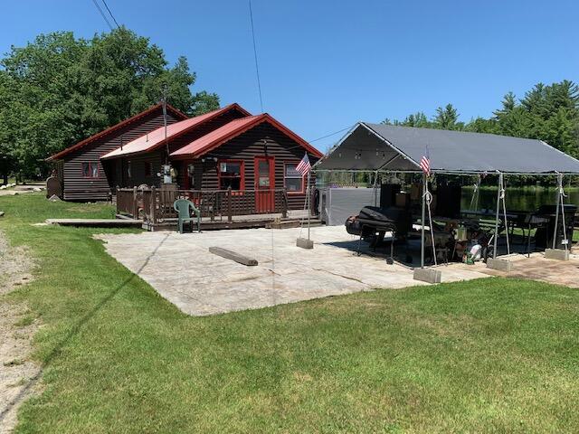 back of house featuring a yard and a carport