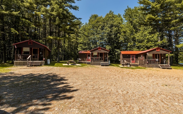 view of yard with a fire pit and a porch