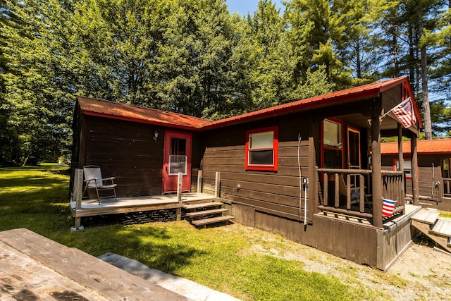 view of front of home with a front yard and a wooden deck